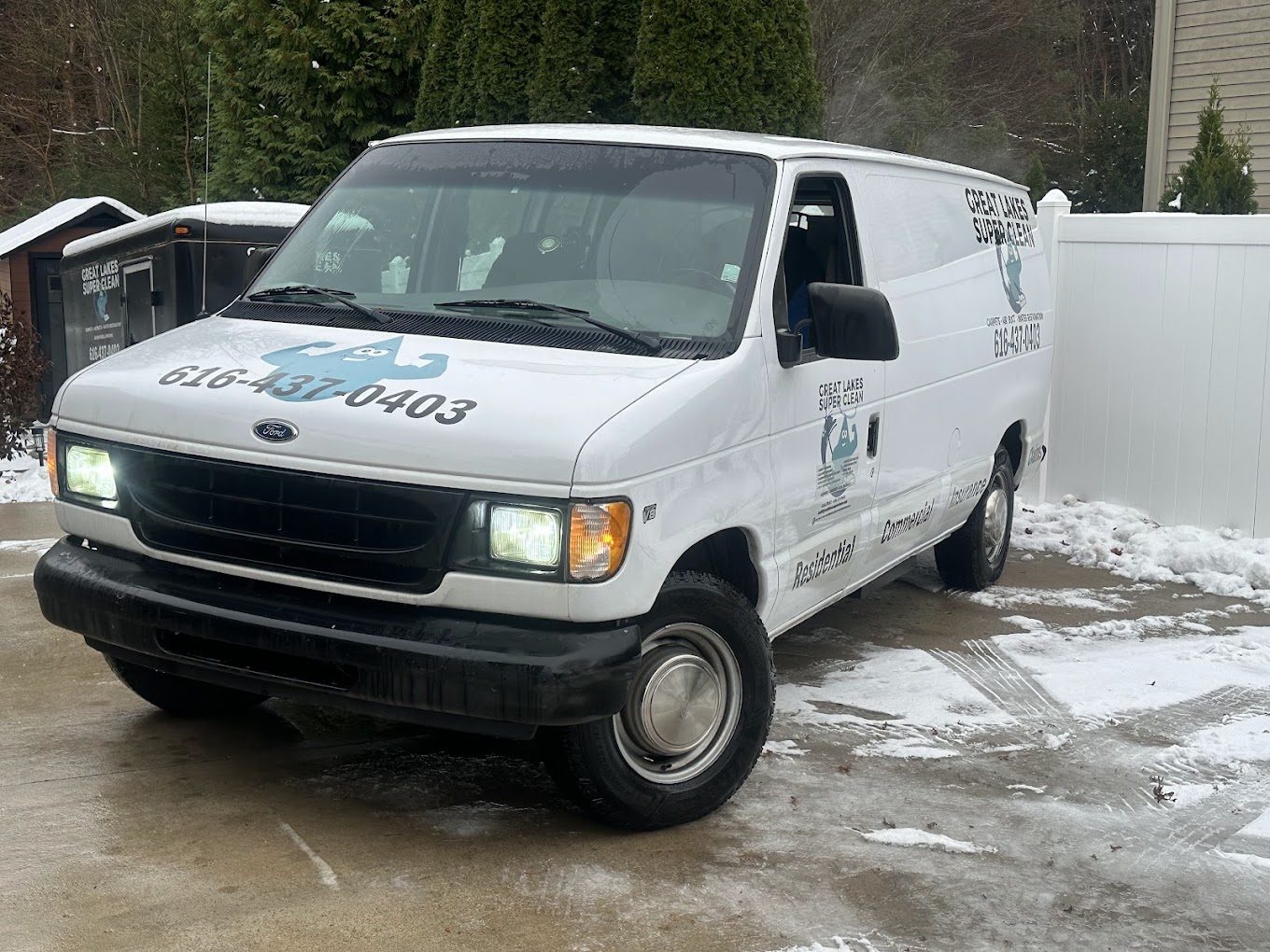 A Great Lakes Super Clean van parked on a snowy driveway on a winter service call