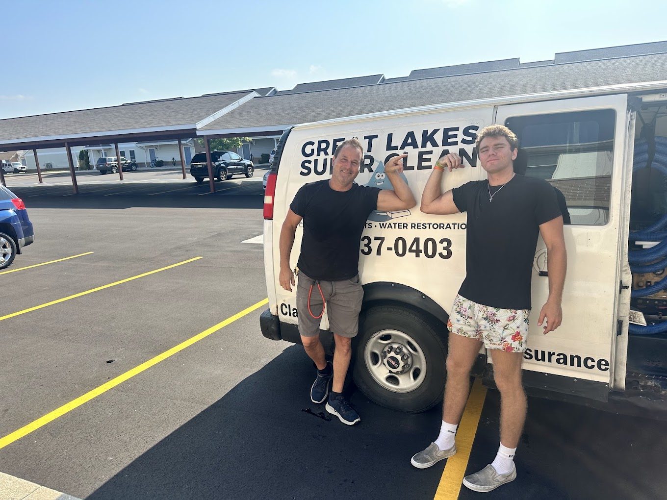 Todd and a crew member standing by a Great Lakes Super Clean van on a job site in Allendale